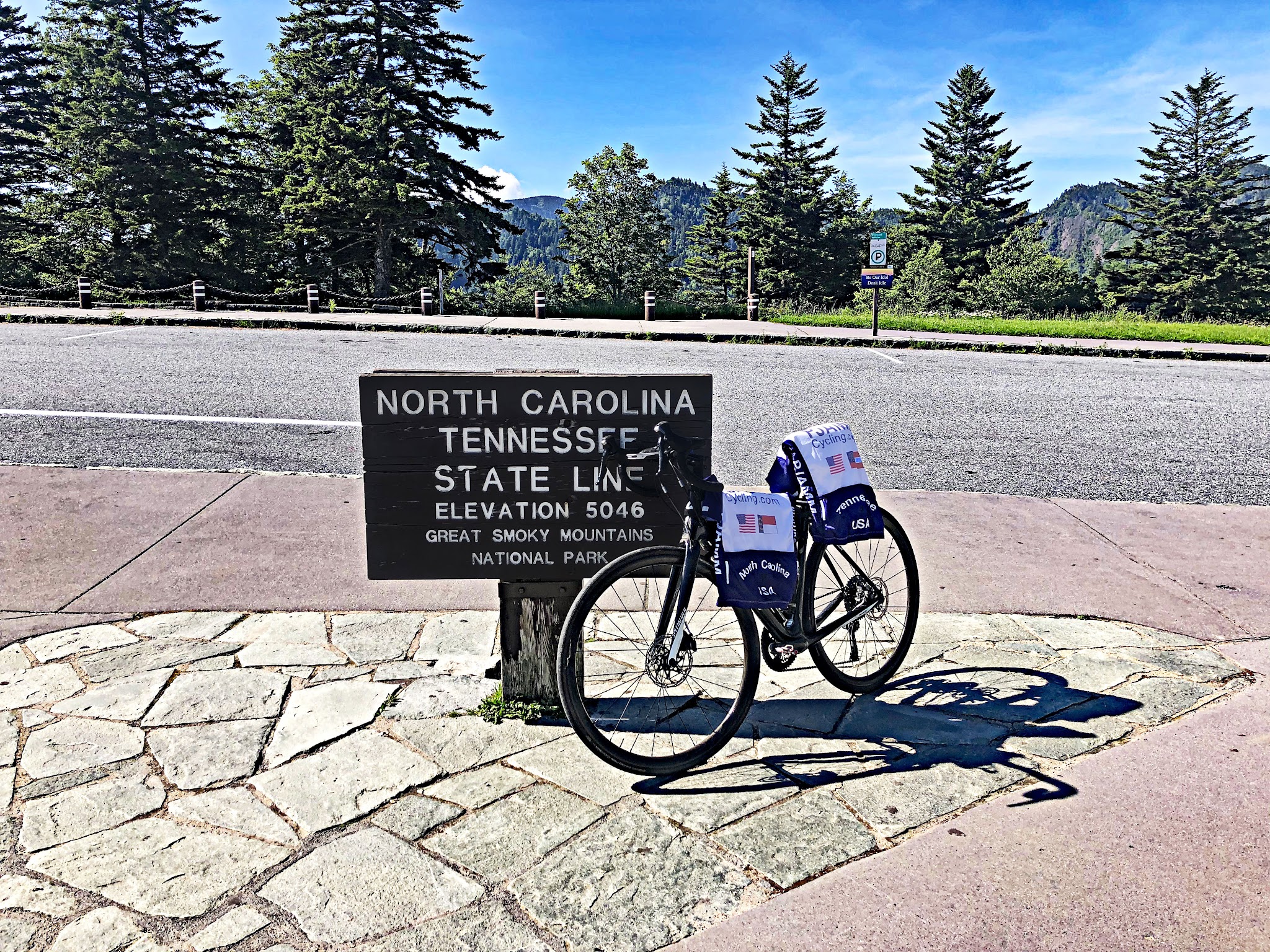 Cycling Clingmans Dome, Tennessee - bike parked next to sign for North Caroline Tennessee State Line, Elevation 5046