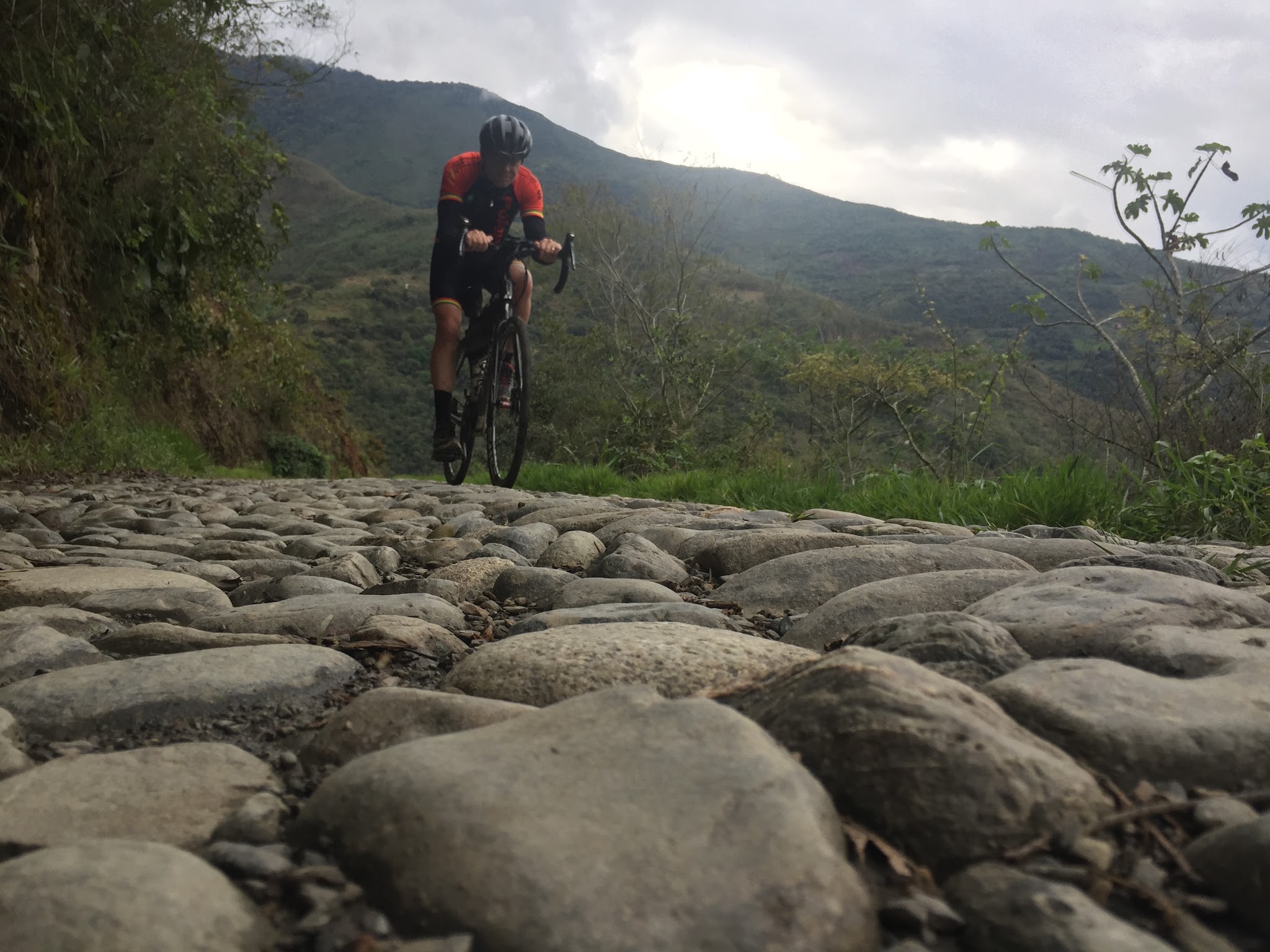 Bicyclist riding over giant cobbles on North Yungas Road