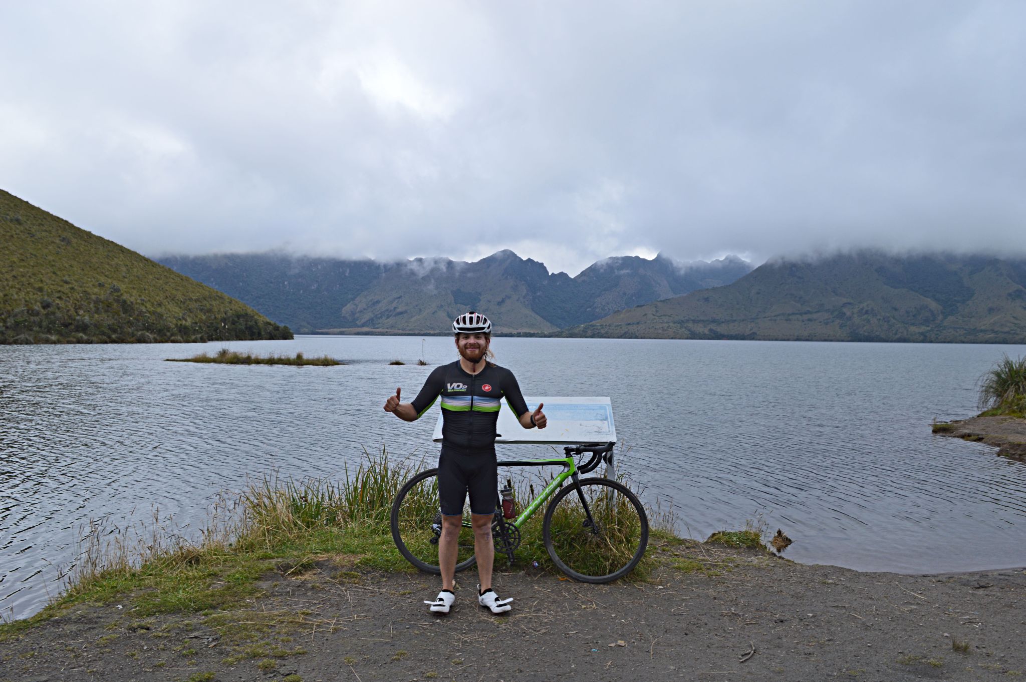 PJAMM Cyclist Hernando stands with two thumbs up next to lake