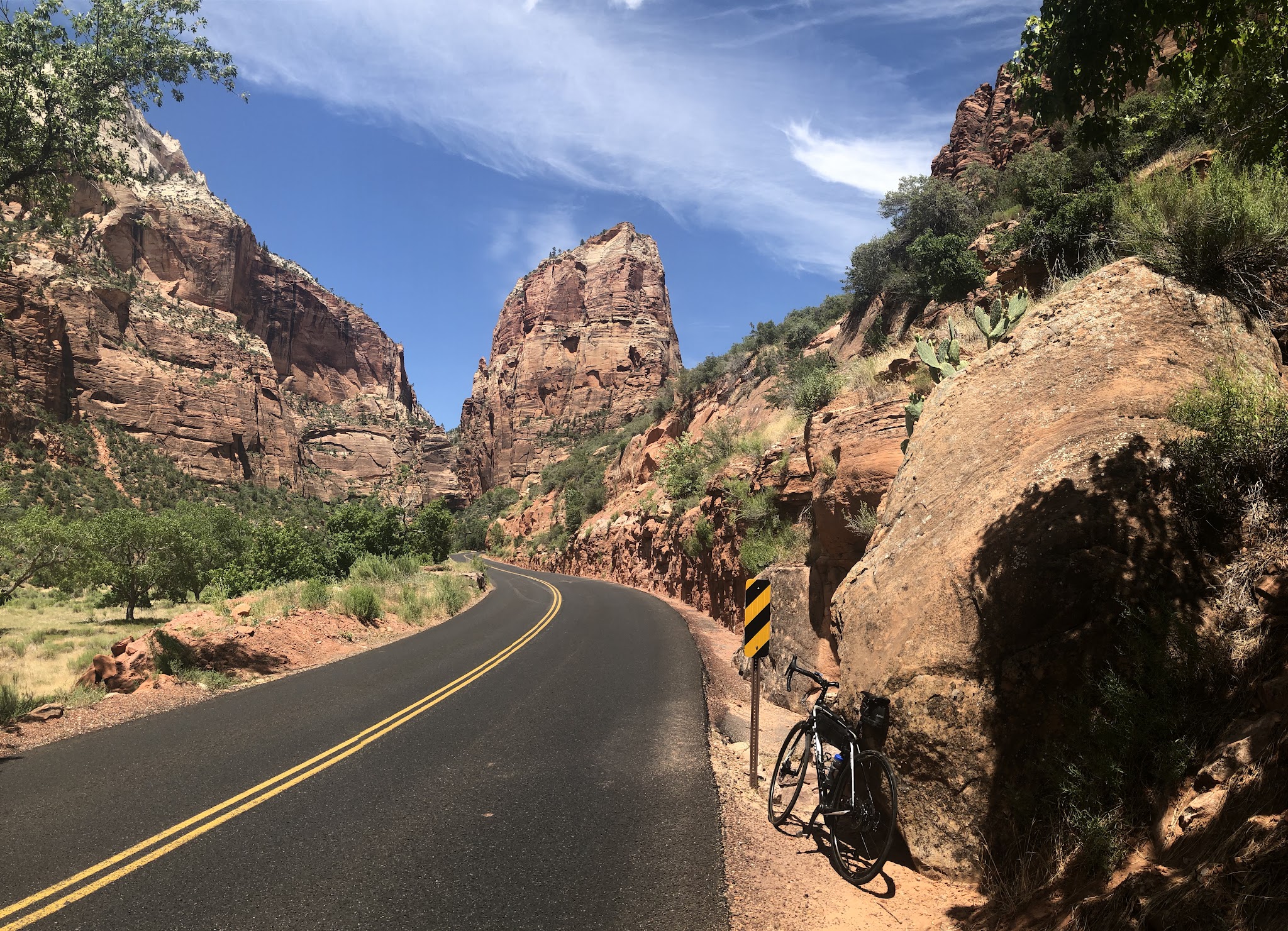 Zion Canyon Scenic Drive Bike climb Zion Canyon Scenic Drive - bike leaning against rock near road with rock formations in background