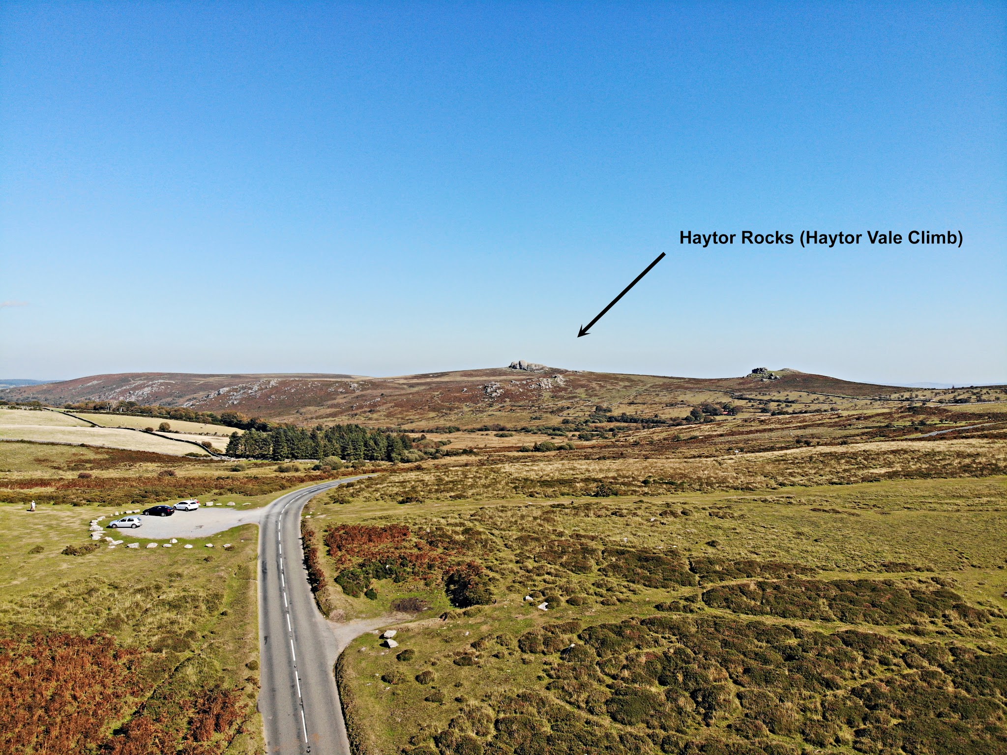 Cycling Widecombe - aerial view of two lane road with car park along side, wide open pastureland