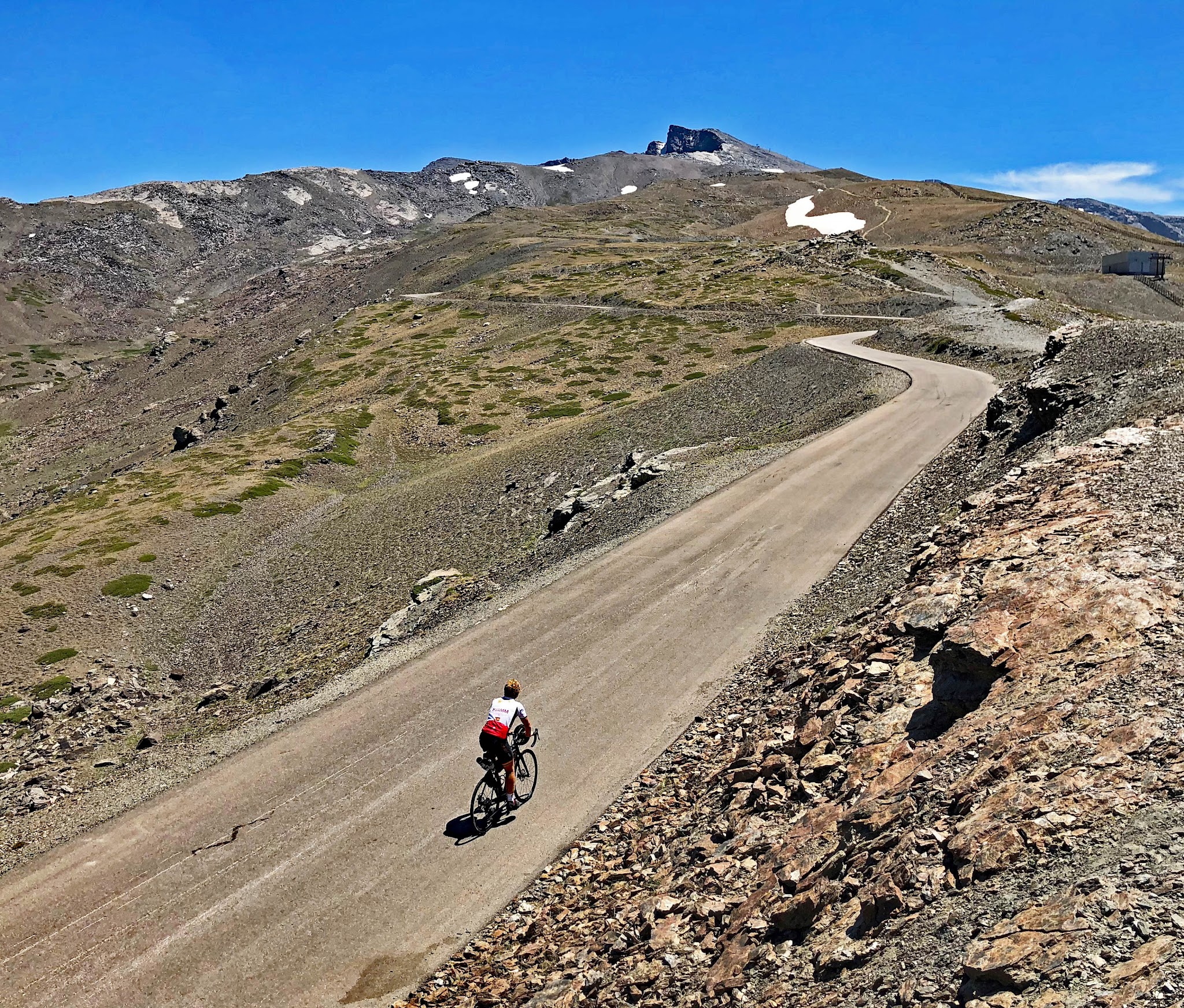 Climbing Pico Veleta by bike - cyclist on road - Pico Veleta summit 