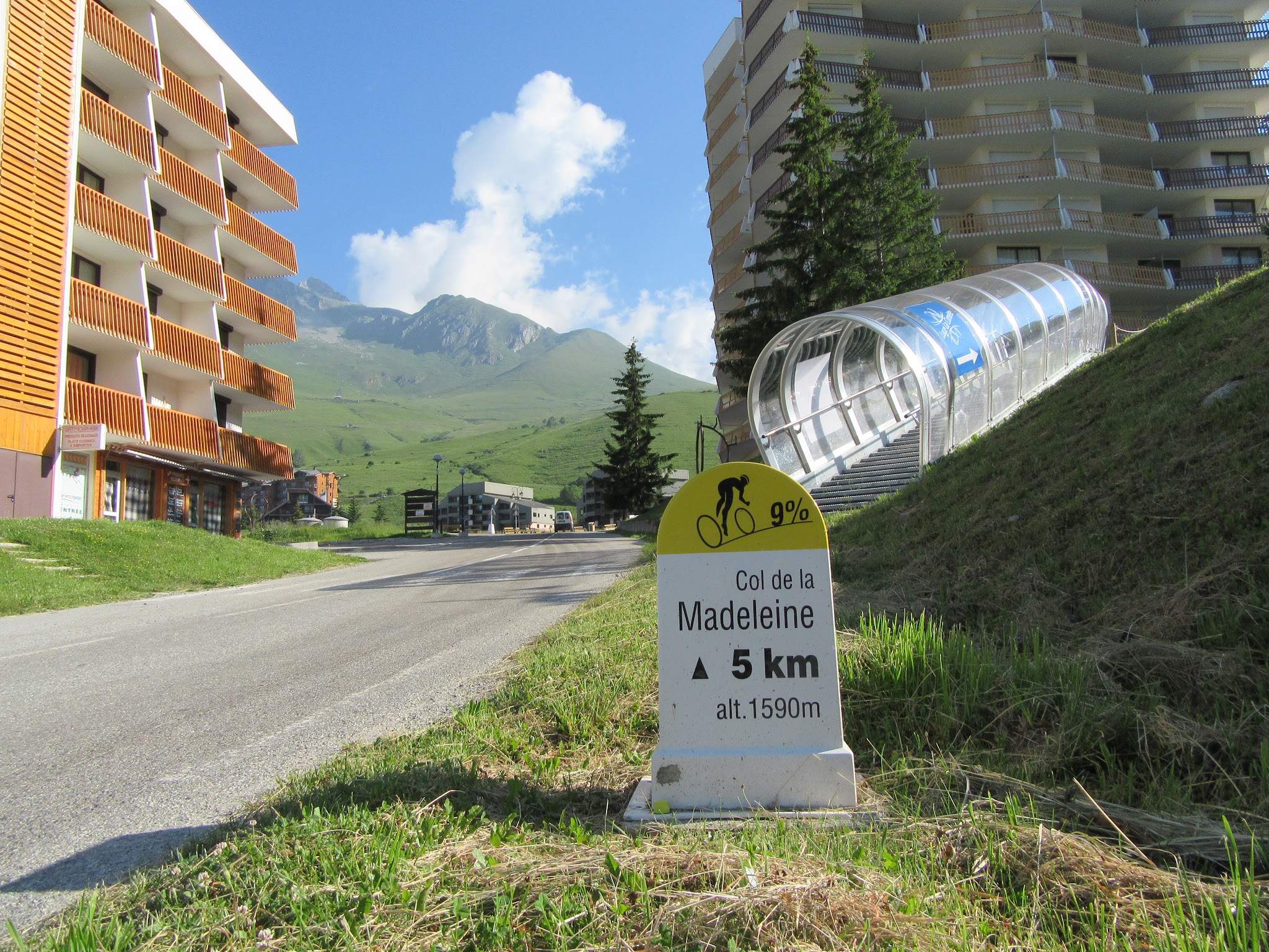 Bicycle ride of Col de Madeleine from La Chambre  - ski resort Longchamp with road, mountain and kilometer marker