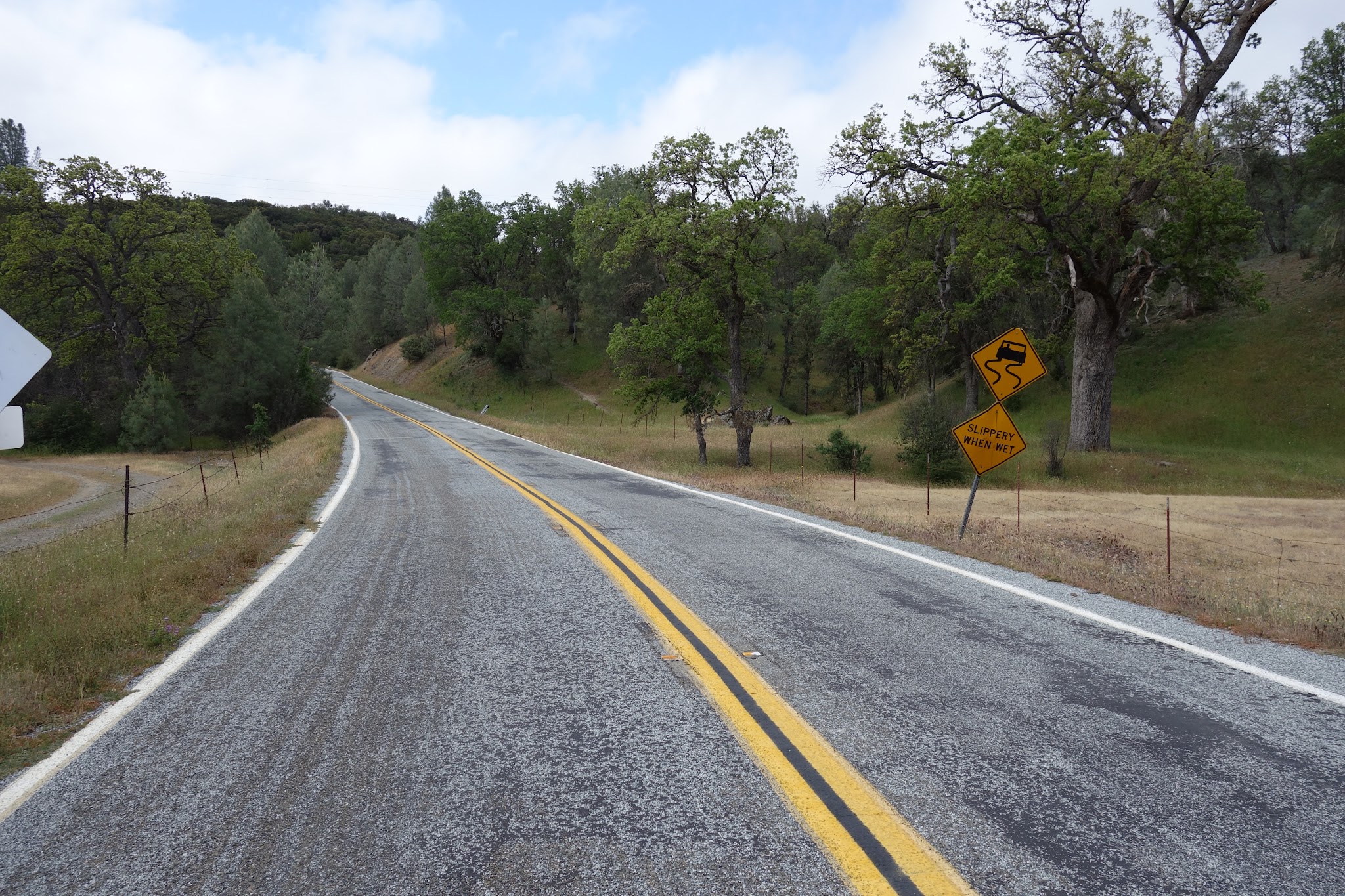 Beginning of Mt. Hamilton East road bike climb - road sign and road. 