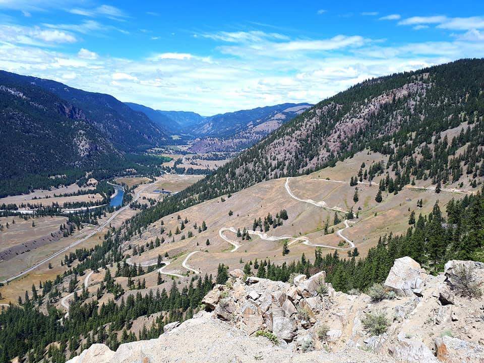 Climbing Hedley to Apex by bike - view of hairpins, meadow and lake