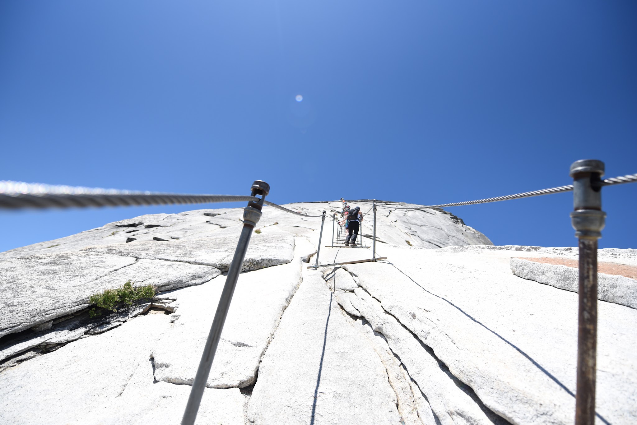 Cycling and hiking Yosemite Valley to Glacier Point to Half Dome -bottom of cables at Half Dome - hikers climbing Half Dome