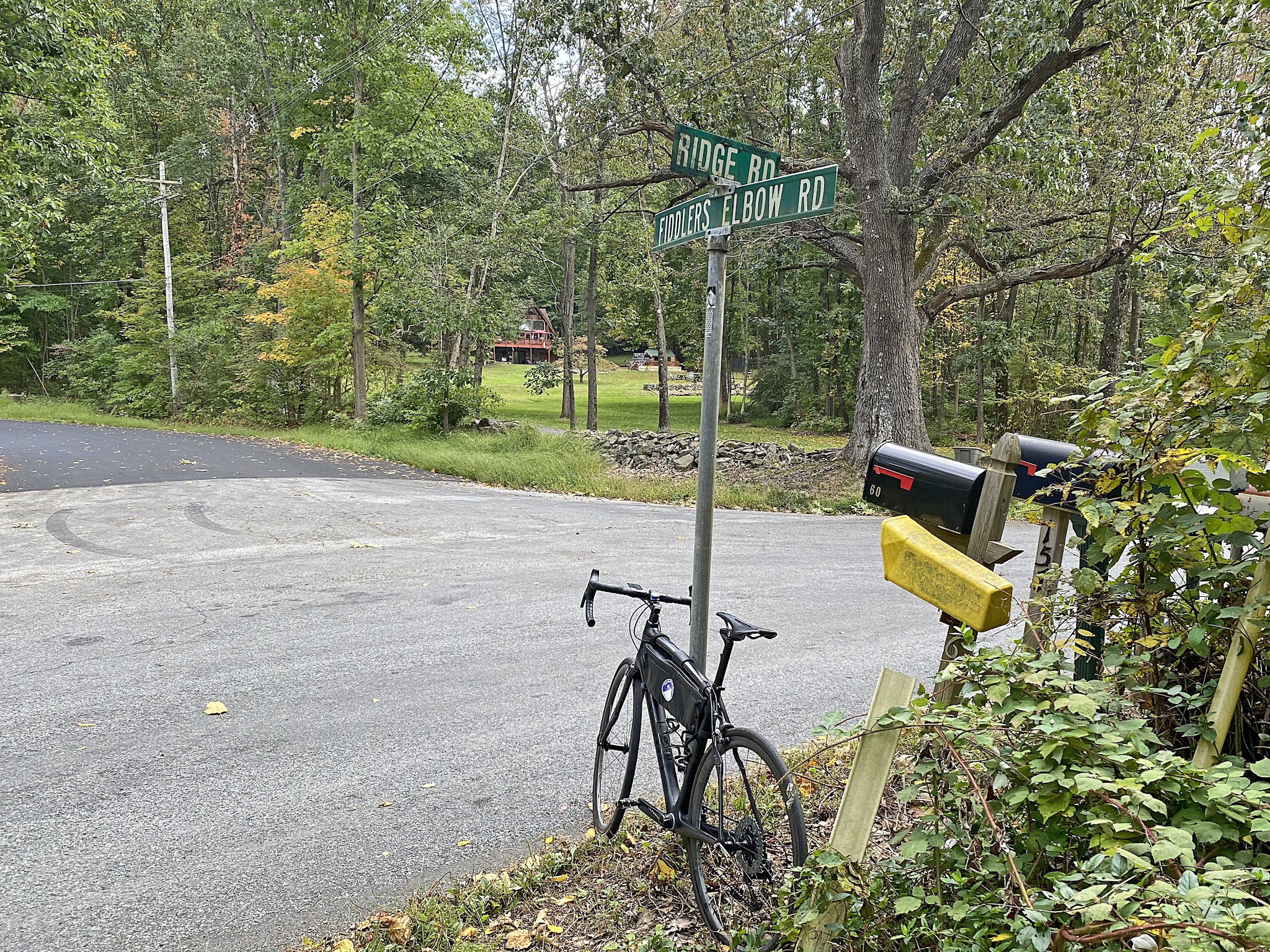 Cycling Fiddlers Elbow, New Jersey - bike parked against road sign at intersection of Ridge Road and Fiddlers Elbow Road