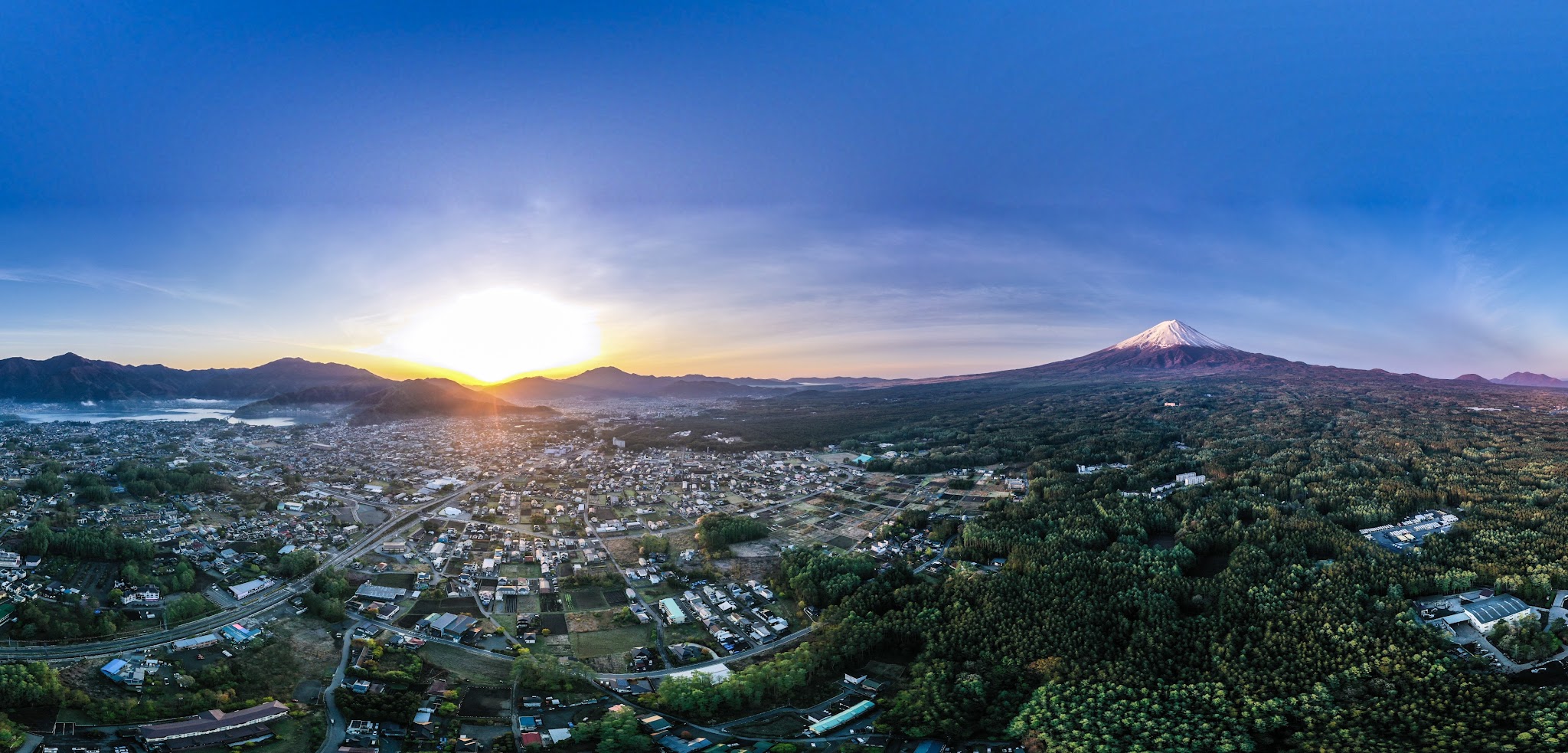 Hardest bike climbs up volcanoes in the world - mt. fuji and city by aerial drone sphere photo