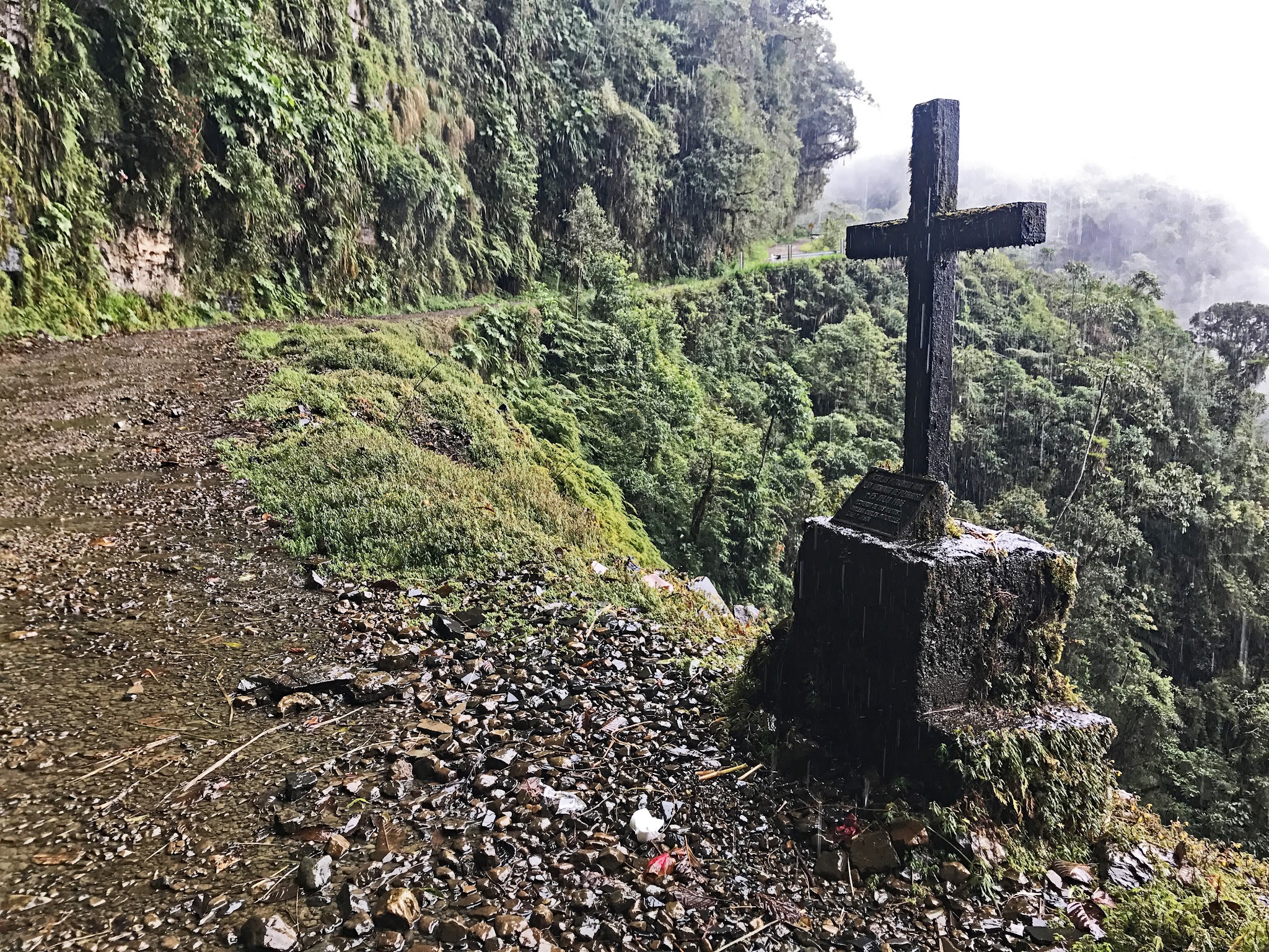 Main memorial cross on death road with narrow road 