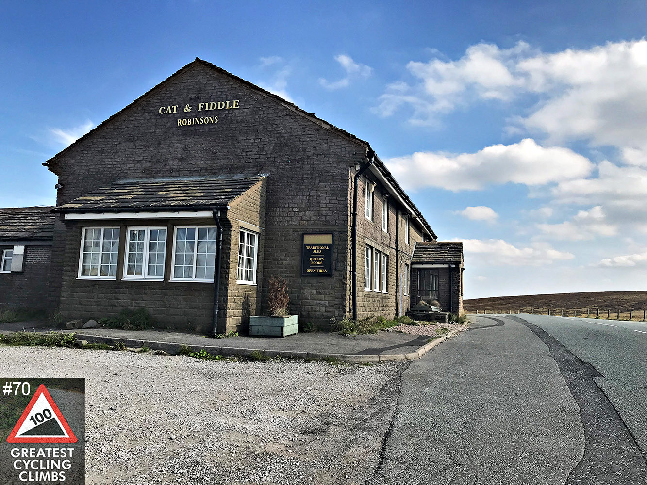 Cycling Cat & Fiddle, England - historic Cat & FIddle Inn at climb's finish, old brick building, blue skies 
