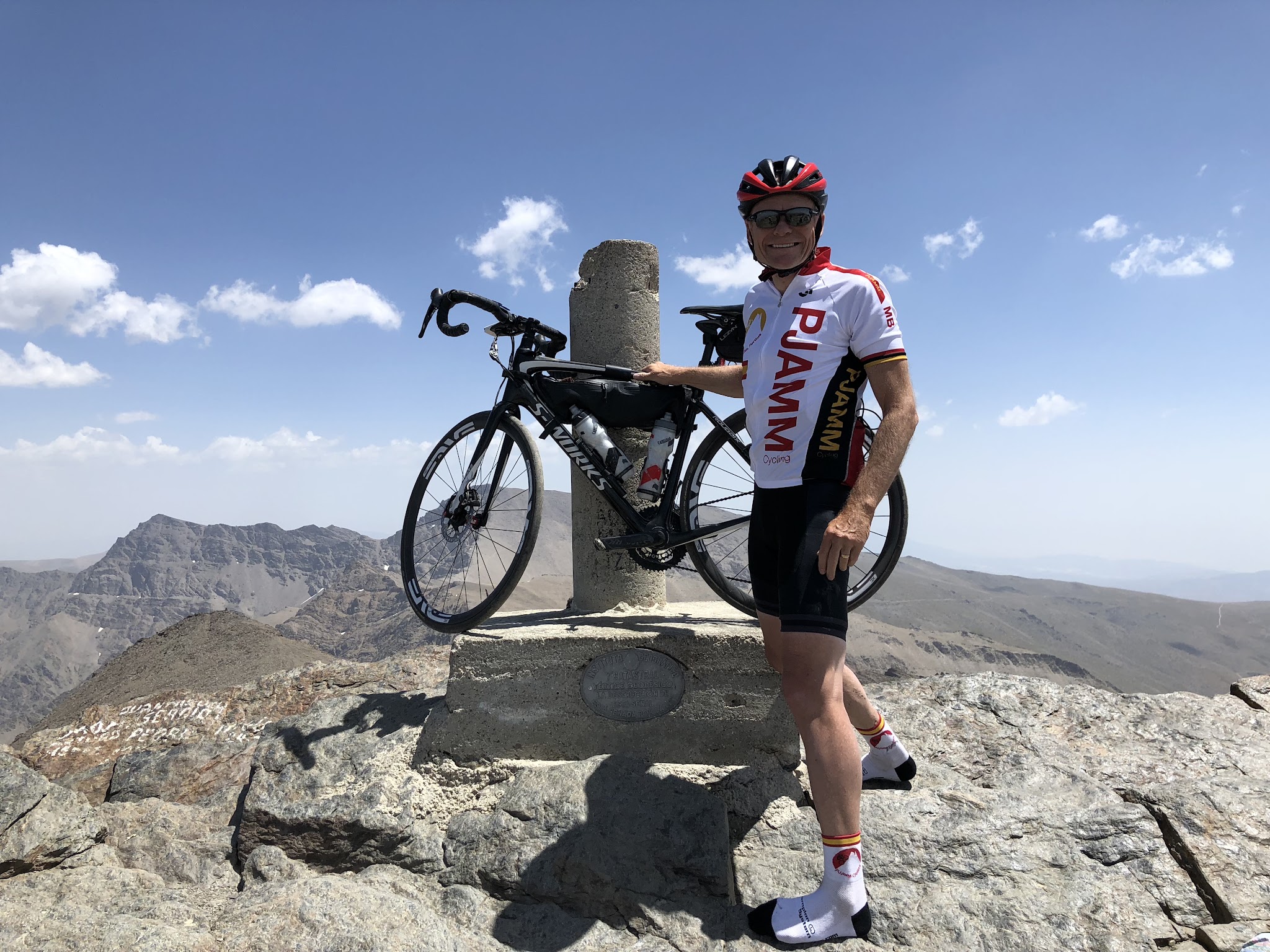 Bicycle and cyclist at the top of Pico Veleta