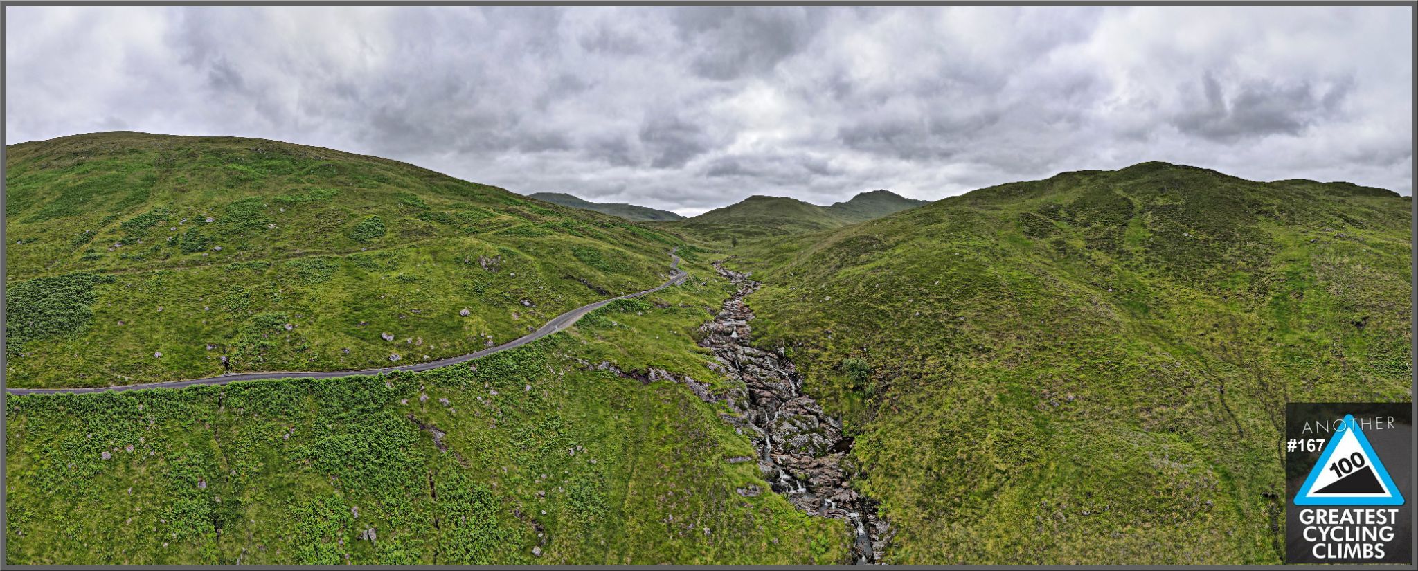 panoramic view of lush green hillside, small waterfall