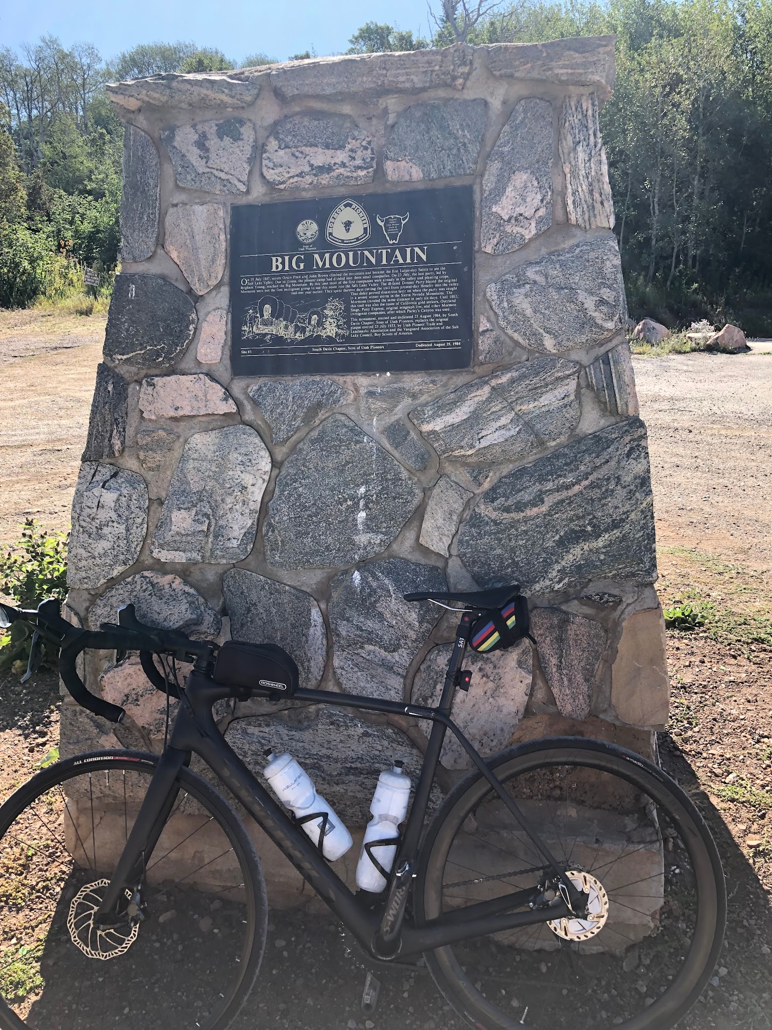Cycling Big Mountain Summit East - bike leaning against summit monument. 