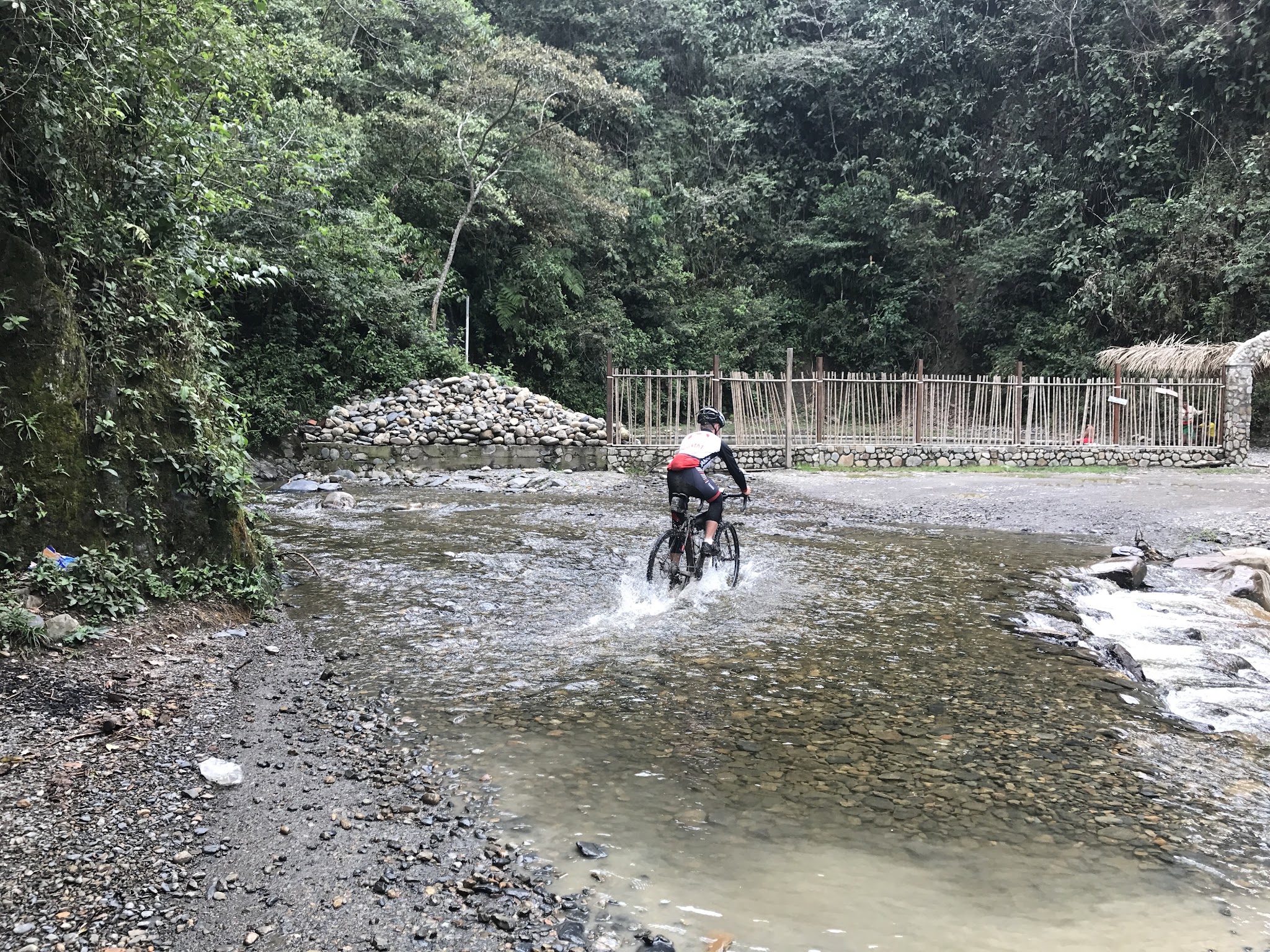 Cyclist crossing river on Death Road 
