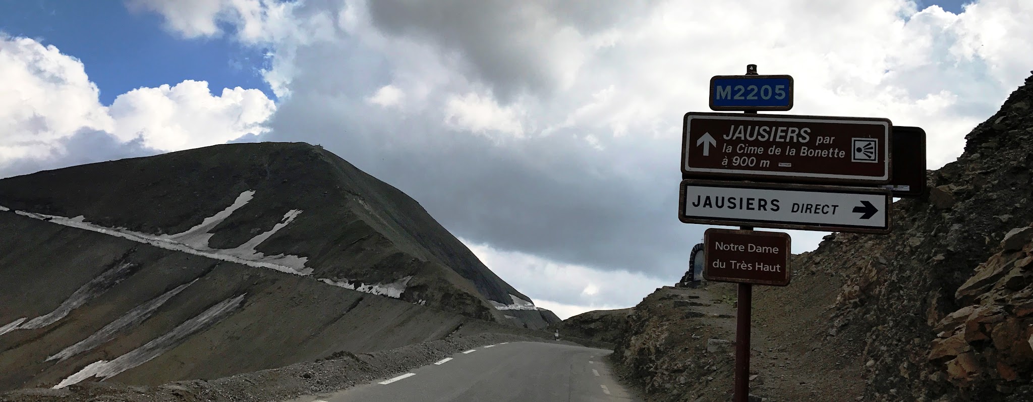 Bicycle ride highest bike climbs in Europe - Cime de la Bonette - pass sign, road and mountain