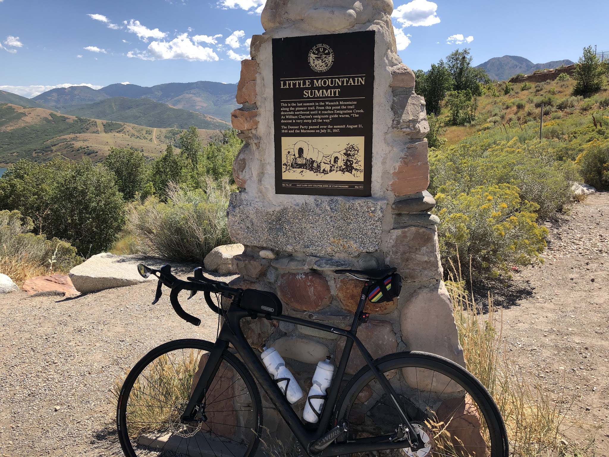 Bicycle ride Big Mountain Summit West - bike leaning against Little Mountain Summit monument. 