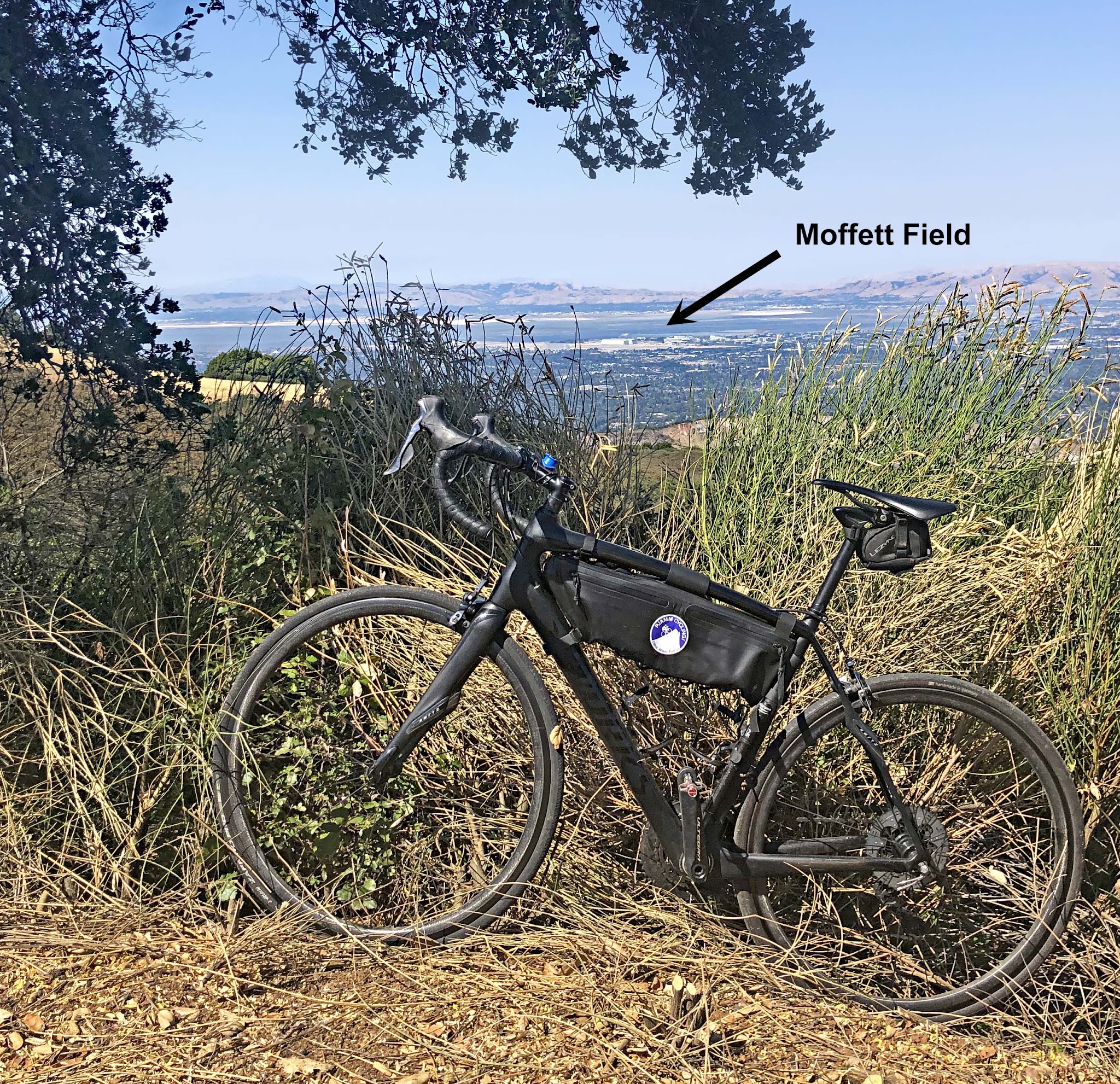 Cycling Montebello, Santa Cruz Mountains, California - road bike parked in brush along hillside overlooking Silicon Valley and Moffett Field