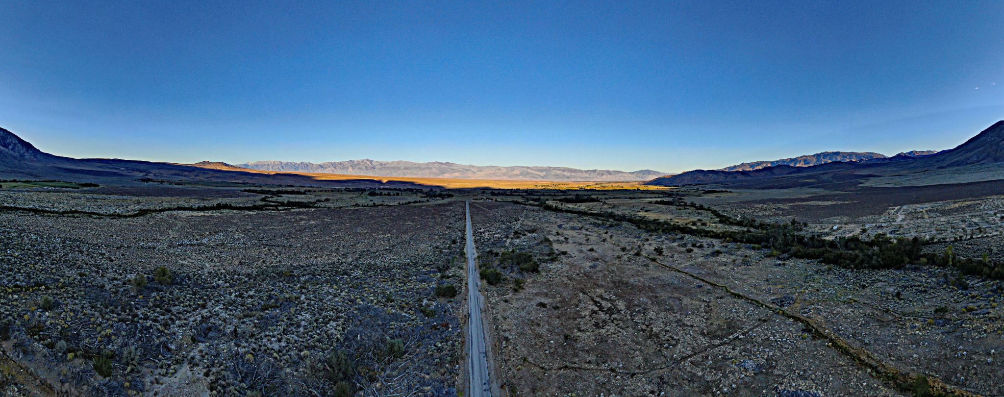 Cycling Pine Creek Road, California - drone photo shows straight, two-lane roadway headed east two miles from start of climb