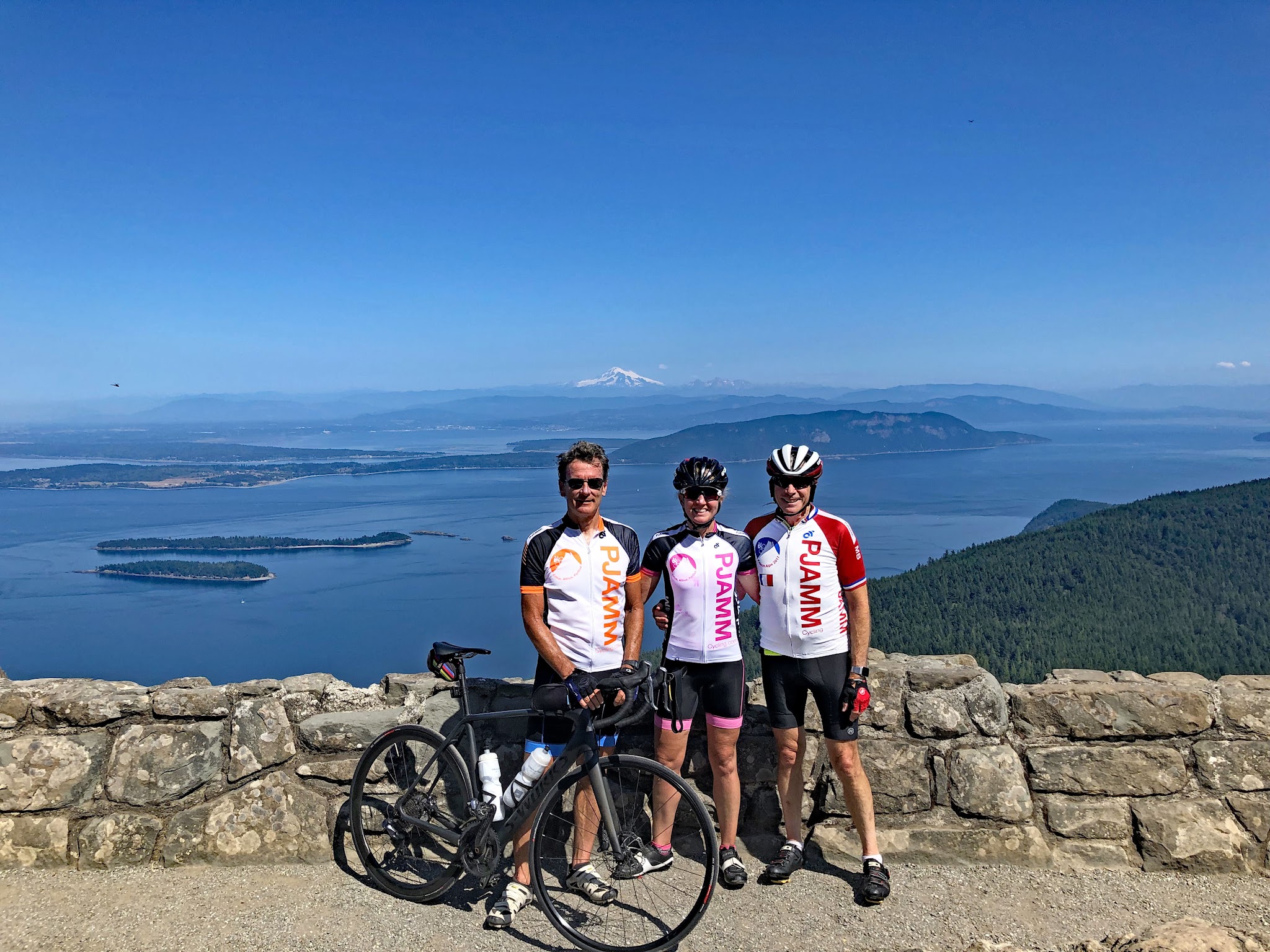 Cycling Mt. Constitution, Washington - three PJAMM Cyclists stand with bikes at summit of ride