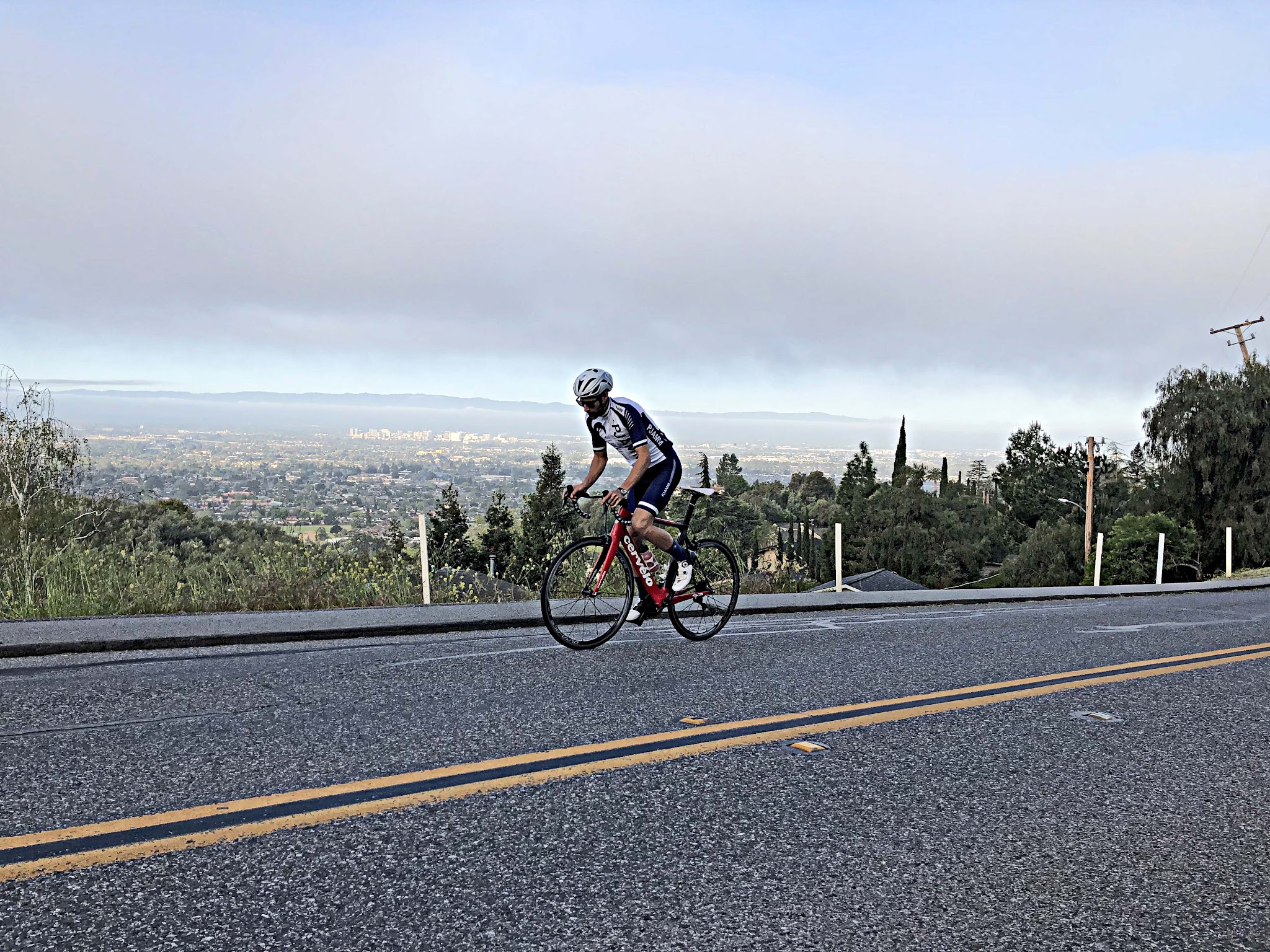 Mt. Hamilton West Cycling Mt. Hamilton - cyclists on bike on road with San Jose and Silicon Valley in background