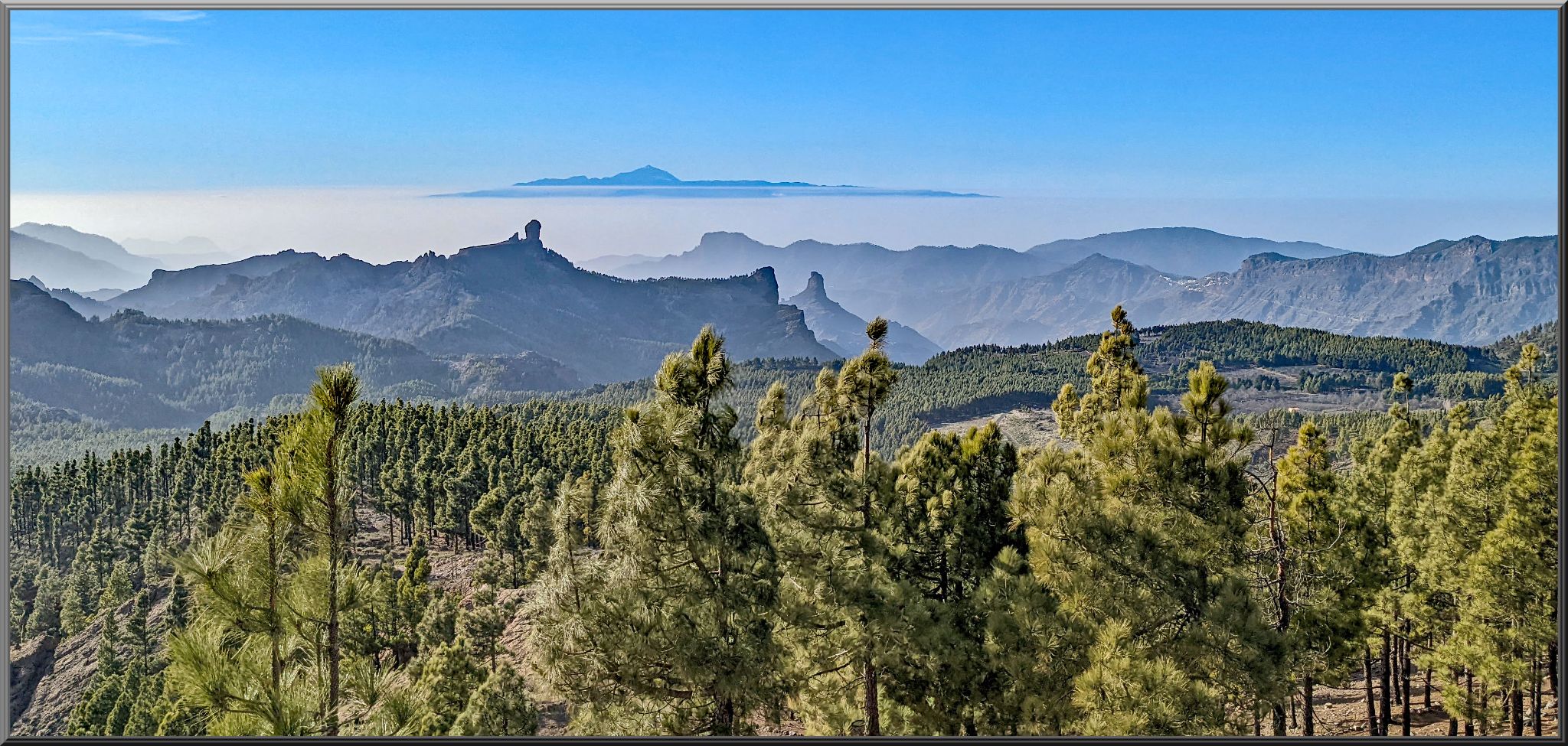 panoramic view of alpine setting with gorgeous mountain silhouettes in distance on Pico de las Nieves climb