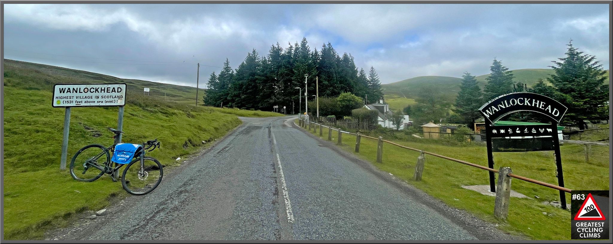 ycling Mennock Pass, Scotland bike parked next to sign reading "Wanlockhead: Highest Village in Scotland"