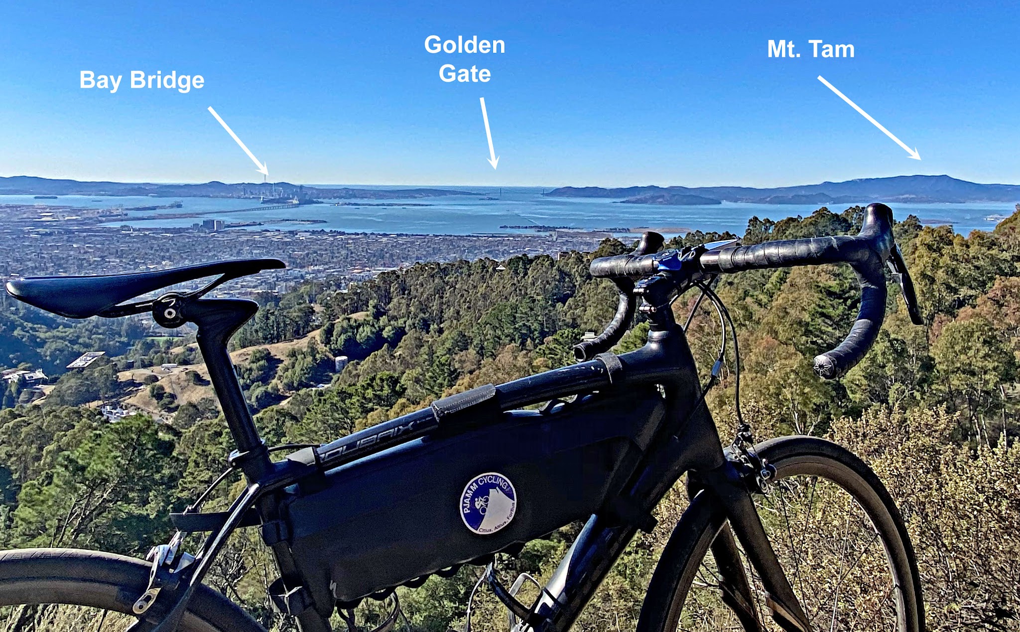 Cycling Tunnel to Grizzly Peak, California - bike parked on hillside overlooking bay views, the Bay Bridge, the Golden Gate Bridge, and Mt. Tam all visible in the horizon