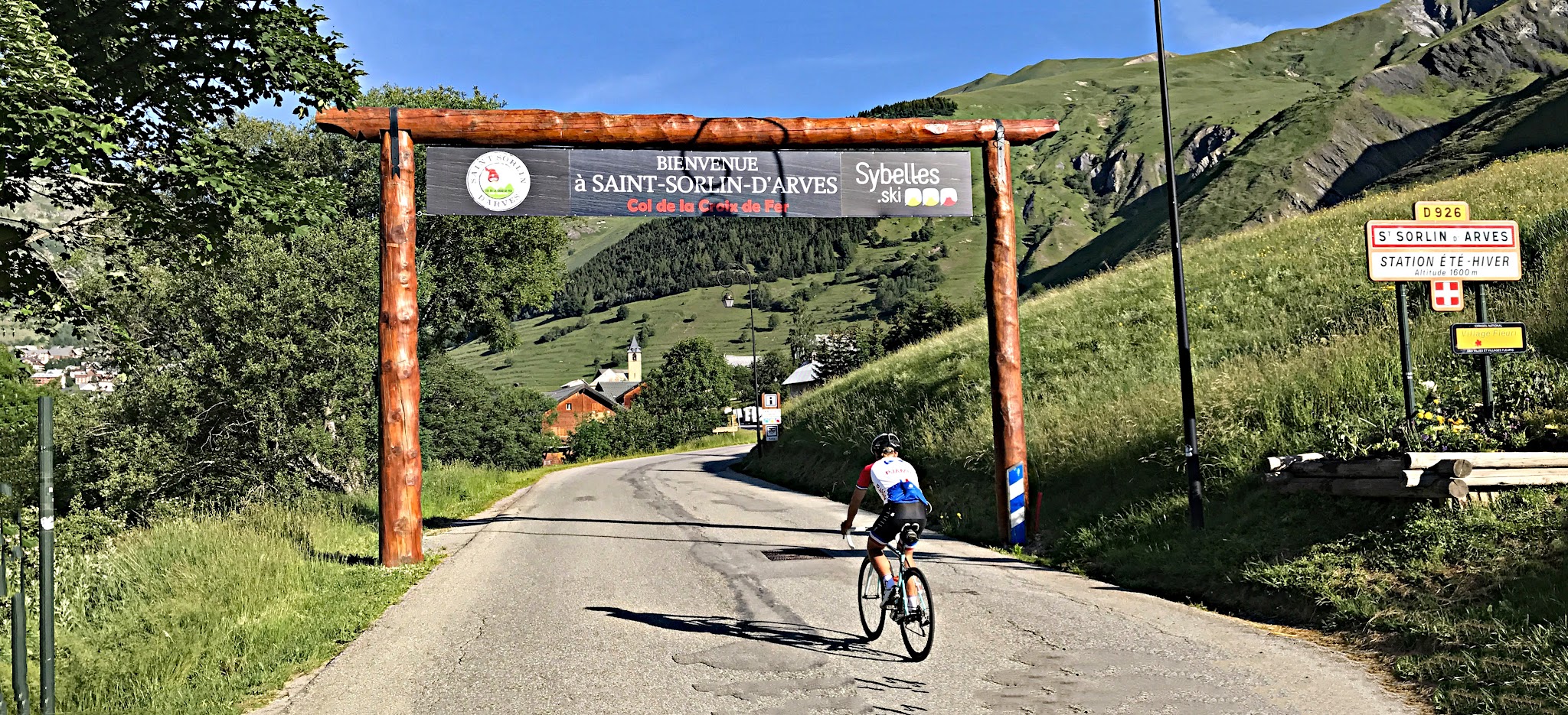 Bicycle ride Saint-Jean-de-Maurienne - cyclist on road going through entrance to Saint-Jean-d-Arves
