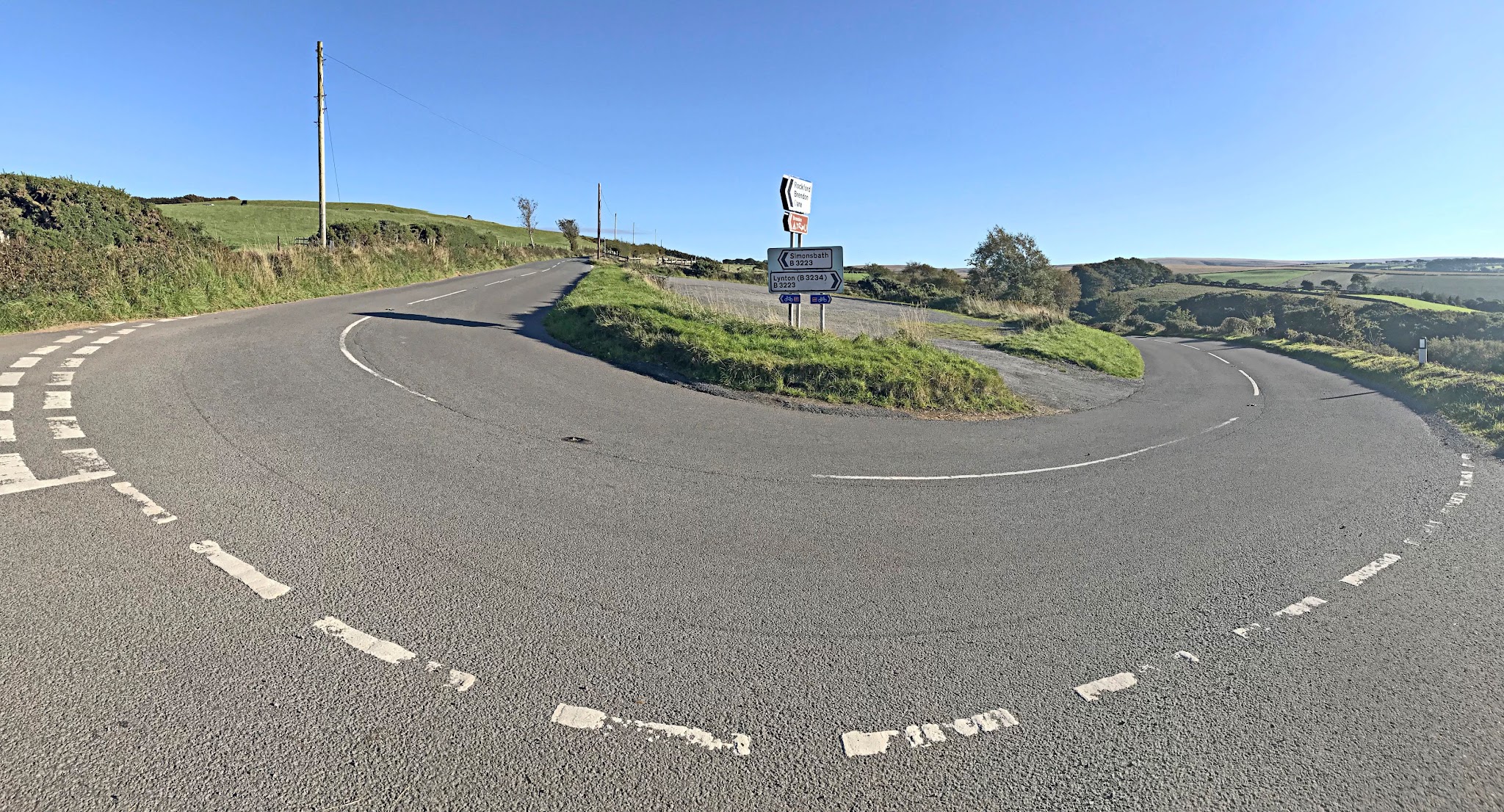 Cycling Exmoor Forest, England - sharp hairpin turn on roadway along hillside