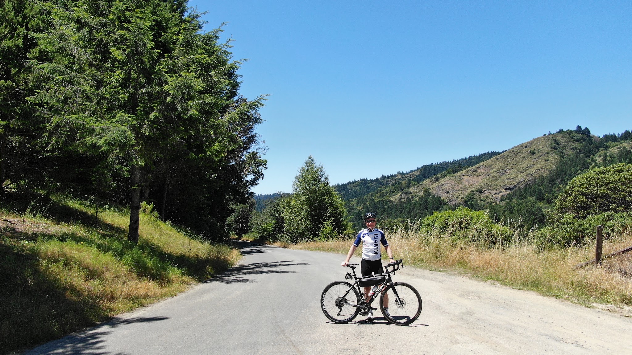 Climbing by bike Sweetwater Springs Road - PJAMM Cycling John Johnson at finish with bike on road