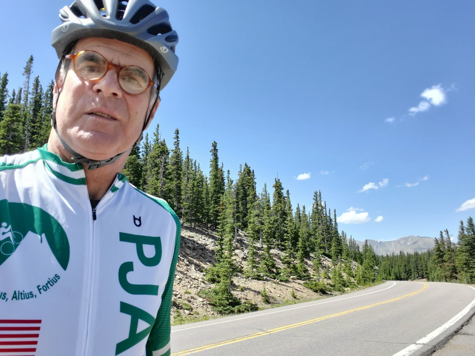 Cycling Juniper Pass East, Colorado - selfie of cyclist wearing PJAMM Cycling jersey along roadside at high point between Squaw Pass and Echo Lake