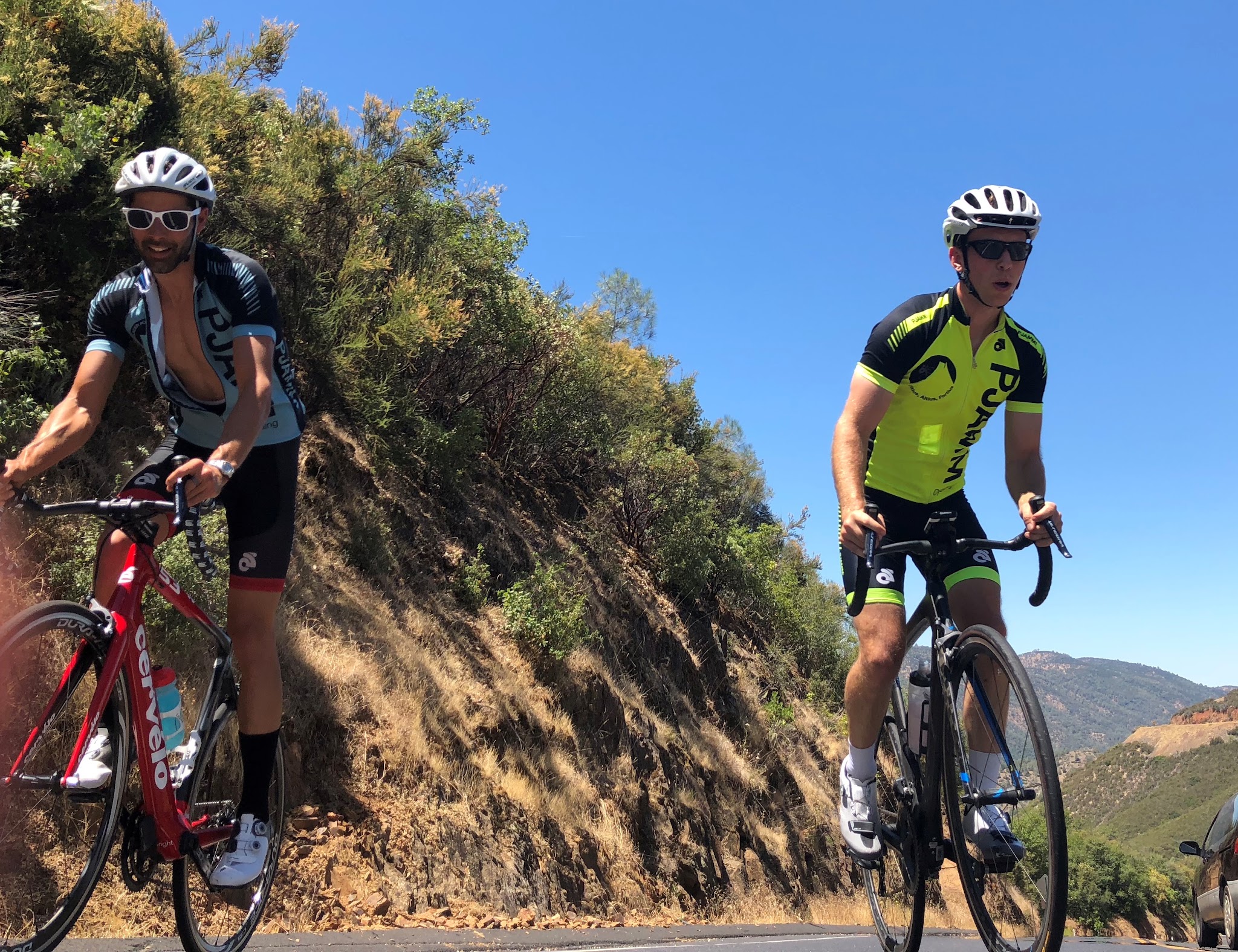Bicycling up Old Priest Grade  - 2 cyclists climbing 