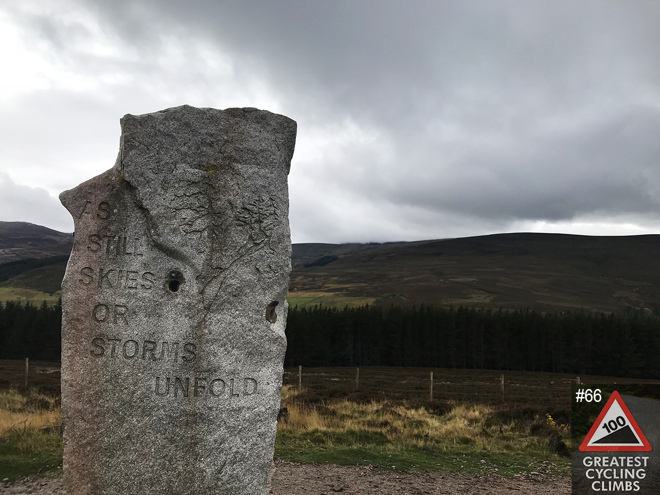 Cycling Lecht Road, Scotland Cycling Lecht Road, Scotland - large tablet-shaped stone with poem carved into it, reading "As Still Skies or Storms Unfold", grey skies in background, Simon Warren's 100 Greatest Cycling Climbs #66 logo in corner