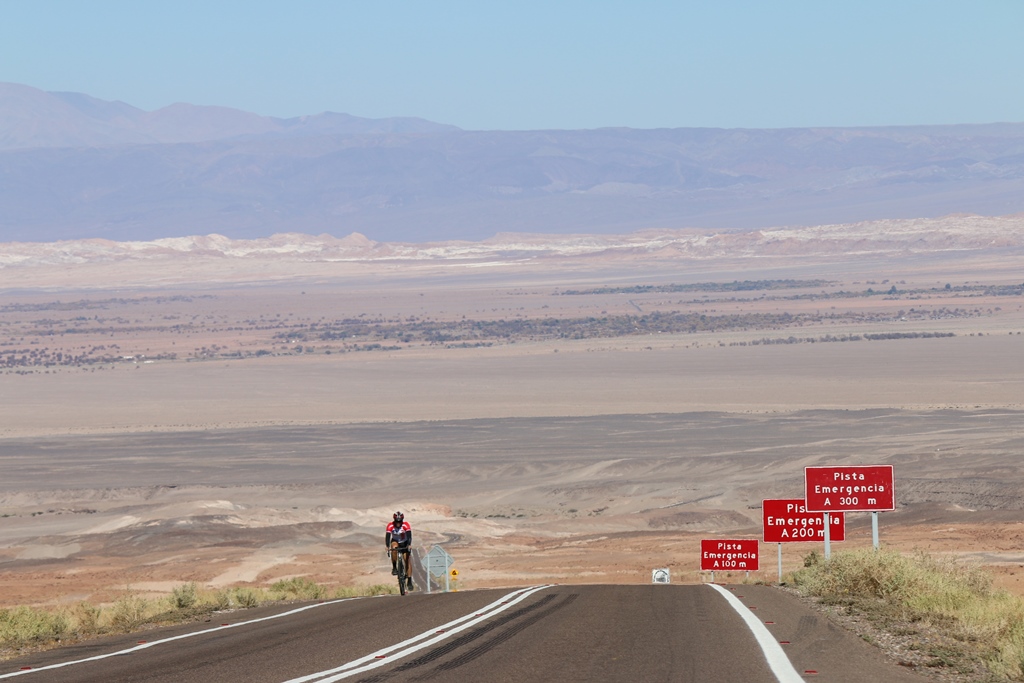 Cycling the top bike climbs in Japan - cyclist riding past Mt. Fuji sign on Fujinomoyi 5th line