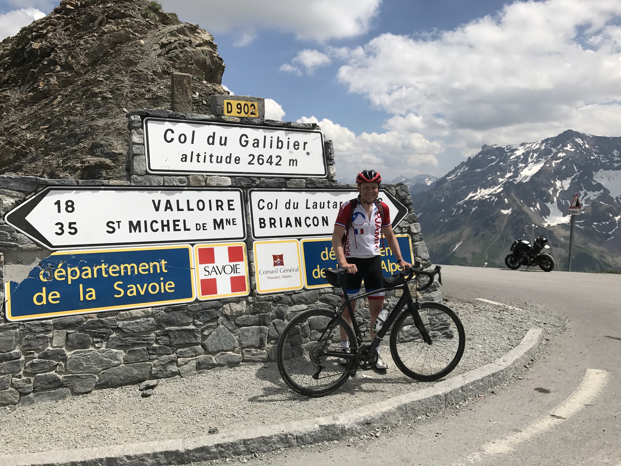 Best climb in Alps - Col du Galibier from Valloire - cyclist at Col du Galibier Col sign